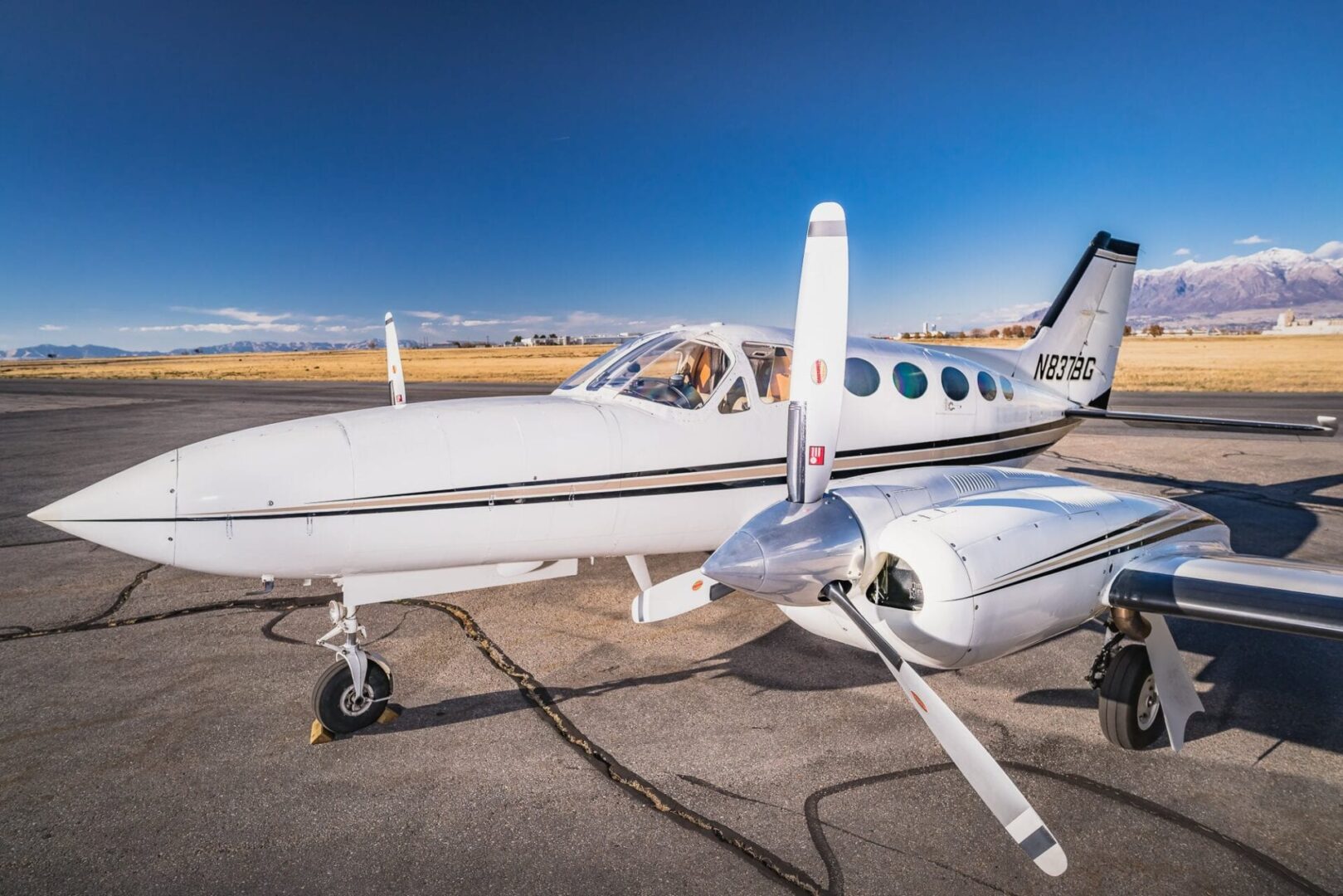 A small white plane sitting on top of an airport runway.