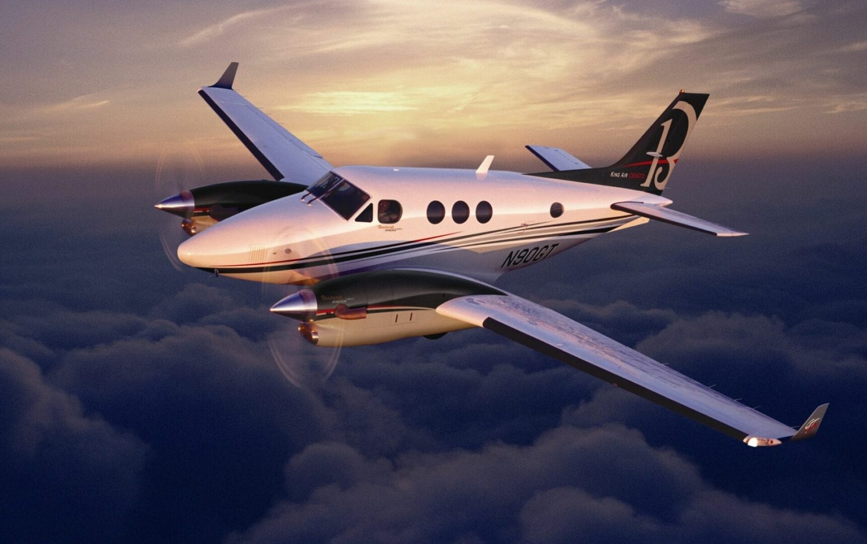 A small plane flying through the sky at sunset.