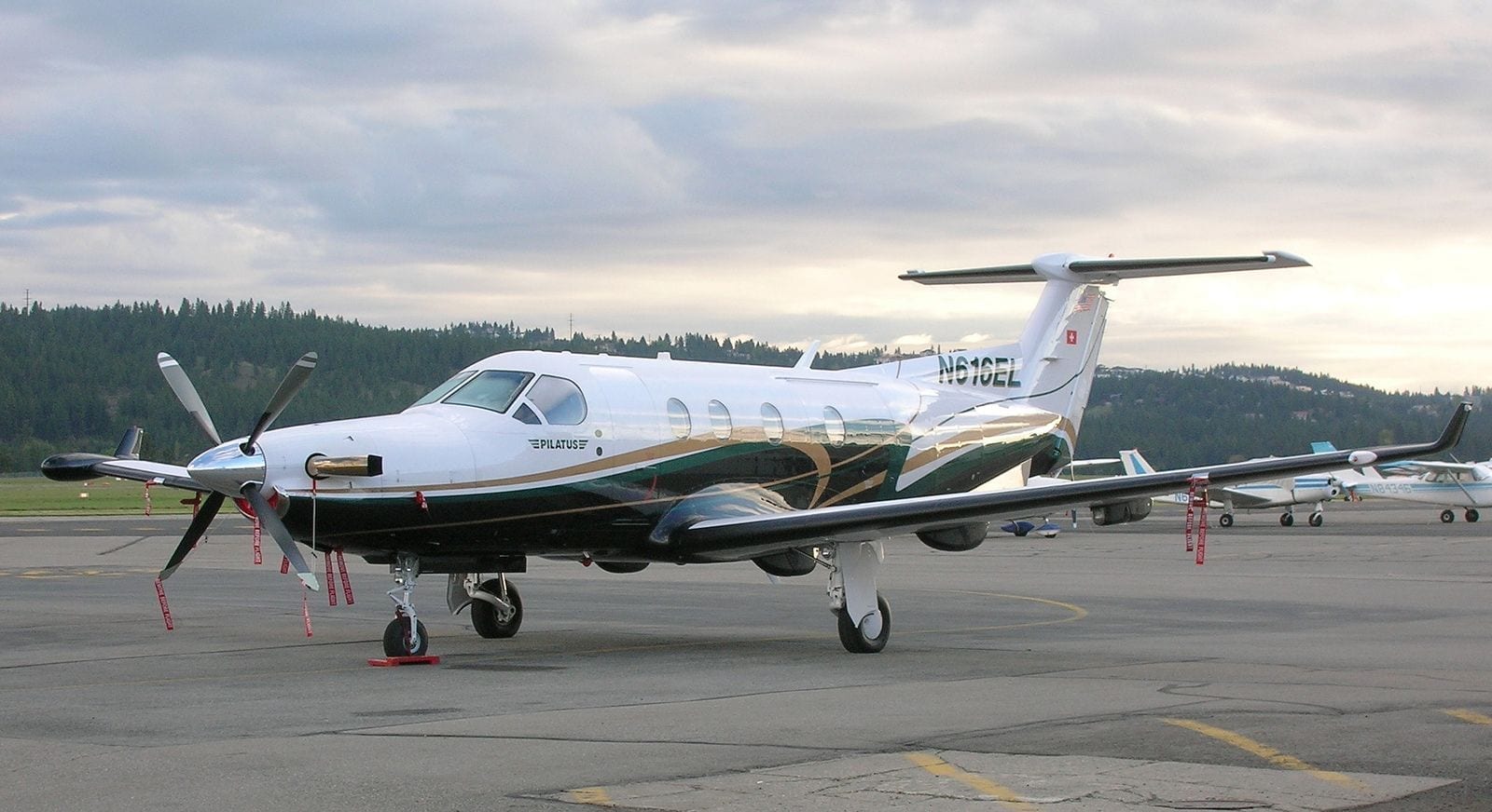 A small white plane sitting on top of an airport runway.