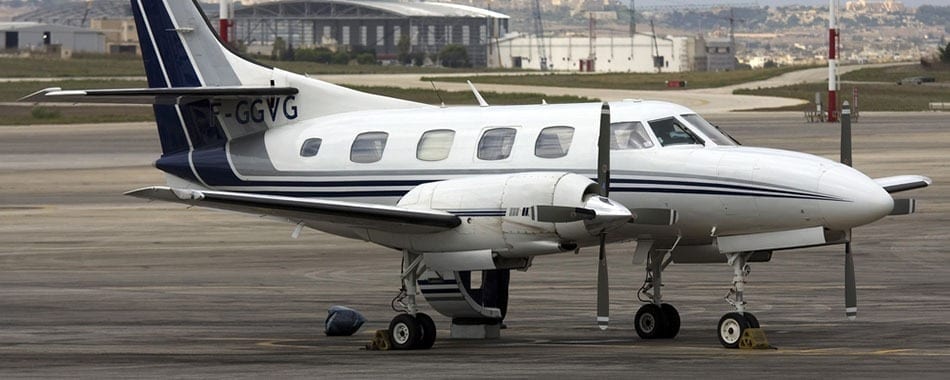 A small white airplane parked on the runway.